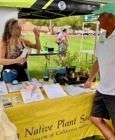 Plantpalooza exhibitor chats with attendee
