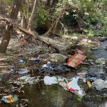 Dirty trashed Arroyo Conejo creek