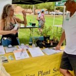 Plantpalooza exhibitor chats with attendee