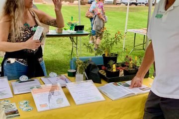 Plantpalooza exhibitor chats with attendee