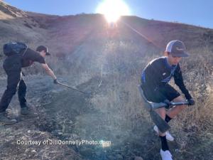 Volunteers (l to r) Brandon Altbush and Jack van der Brug of  the El Camino Real charter high school mountain bike team fill in a hole on the trail.Photo: Jill Connelly